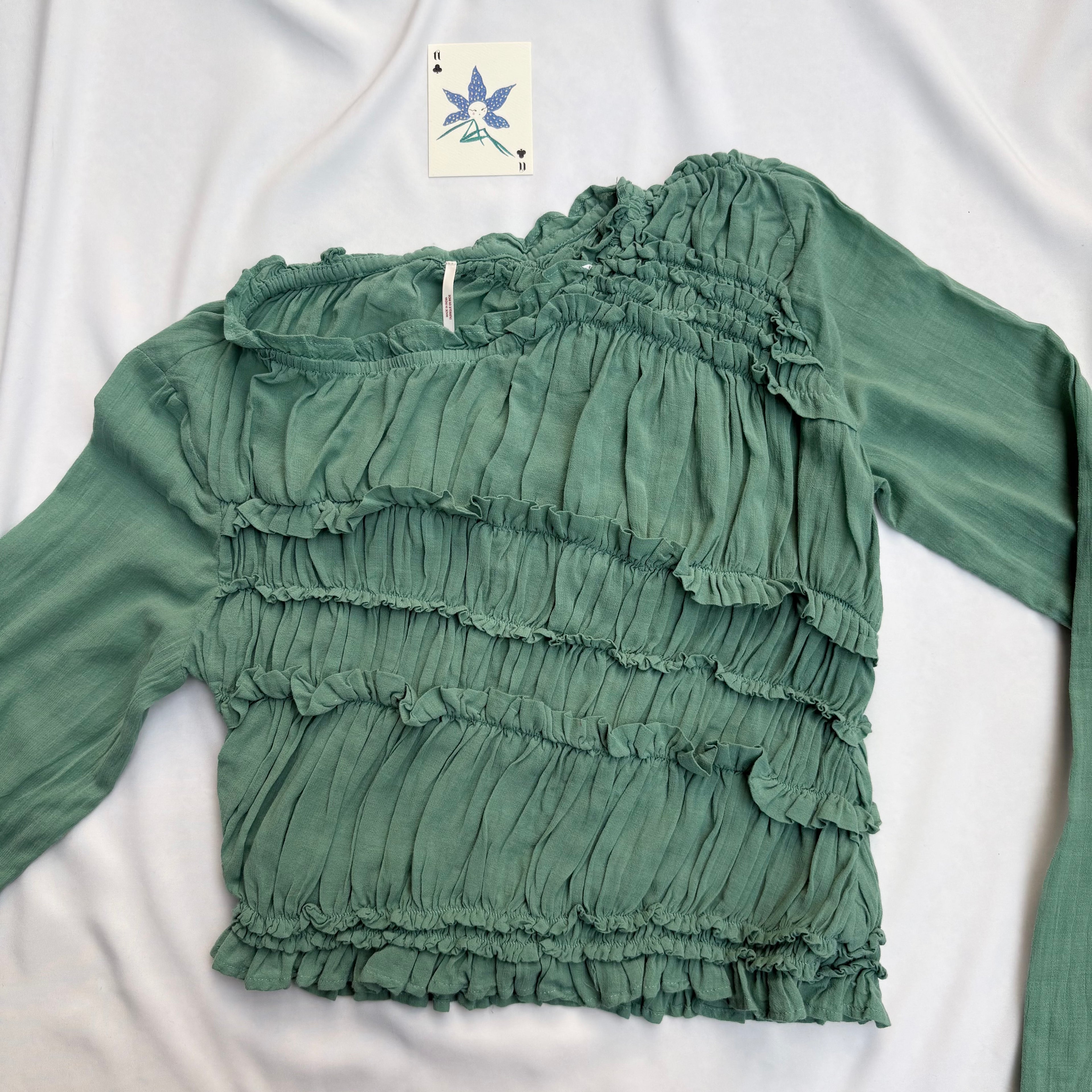 GREEN ASYMMETRIC RUFFLE TOP FROM FREE PEOPLE
