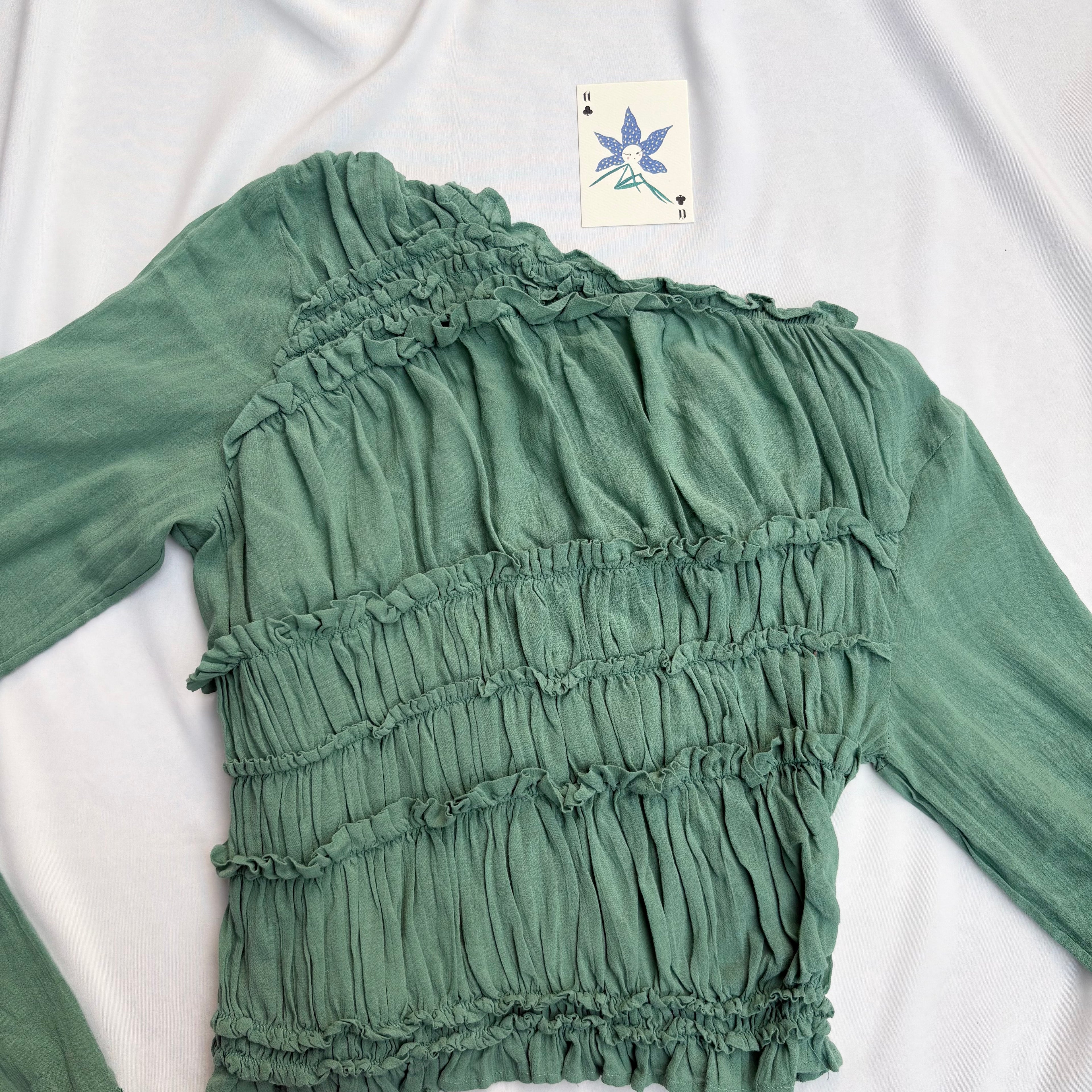 GREEN ASYMMETRIC RUFFLE TOP FROM FREE PEOPLE